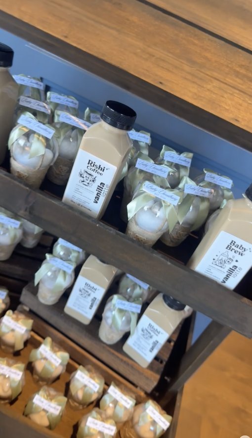 Rishi Coffee bottles on a rustic shelf at a baby shower