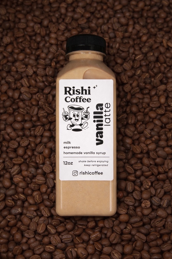 Rishi Coffee vanilla latte bottle lying on a bed of coffee beans