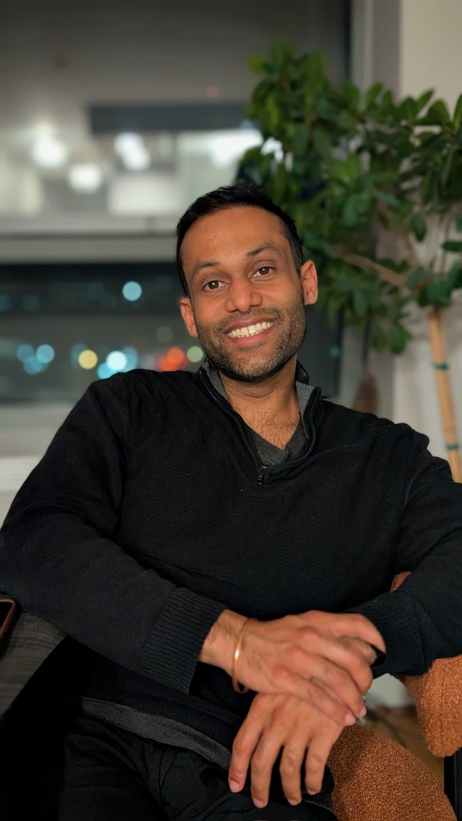 Rishi, founder of Rishi Coffee, smiling in a black sweater